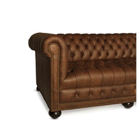 Leather Chesterfield sofa with rolled arm, side angle.