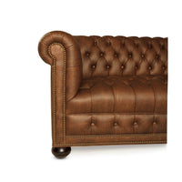 Leather Chesterfield sofa armrest with nailhead trim detailing.