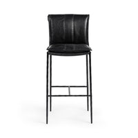 Front view of the slim-frame black leather bar stool with a padded back, stitched seat and iron footrest