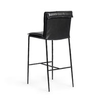 Three-quarter rear view of the slim-frame black leather bar stool, showing the smooth back and rolled top edge
