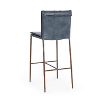 Three-quarter rear view of the slim-frame blue leather bar stool, showing the smooth back and rolled top edge