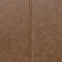 Close-up of the bench upholstery showing brown leather grain and a stitched channel seam