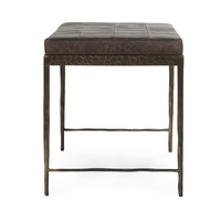 End view of the Cocoa Brown leather bench showing its patchwork cushion and iron side stretchers