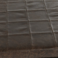 Close-up of the Cocoa Brown bench’s leather seat showing stitched square panels and natural grain