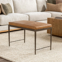 Sedona Brown leather bench with a hammered iron base on a cream rug in front of a sofa