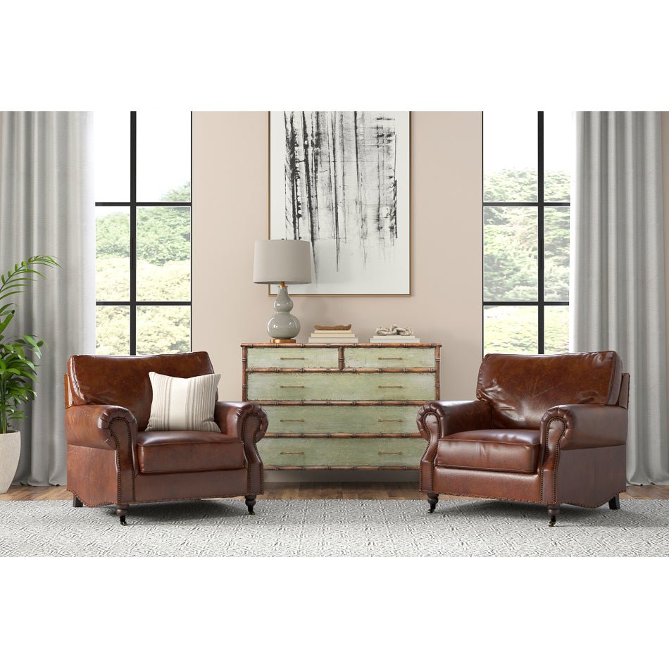 Room setting with two brown leather club chairs.