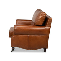 Brown leather club chair, side profile.