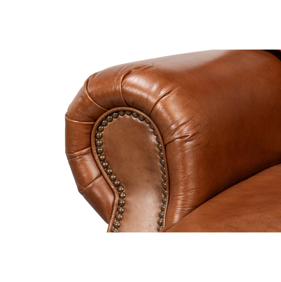 Brown leather club chair, close-up of arm and nailhead.