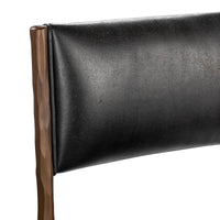 Close-up of the rectangular black leather backrest and hammered iron upright