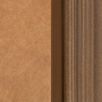 Material detail of tan leather upholstery beside the bronze-toned iron frame.