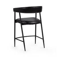 Three-quarter rear view of the black leather counter stool showing the curved back rail and tapered legs