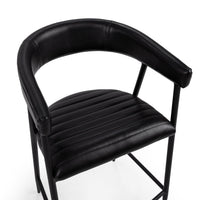 Overhead detail of the curved black leather back and arms around the channel-stitched seat