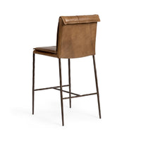 Three-quarter rear view of the slim-frame tan leather counter stool, showing the smooth back and rolled top edge