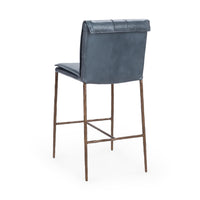 Three-quarter rear view of the slim-frame blue leather counter stool, showing the smooth back and rolled top edge