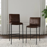 Dark brown slim-frame leather bar and counter stools displayed together beside a window