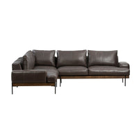 Angled view of brown leather sectional showing broad seat cushions and the corner return in the foreground