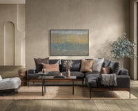Brown leather sectional styled with accent pillows, a throw and a rectangular coffee table in a neutral living room