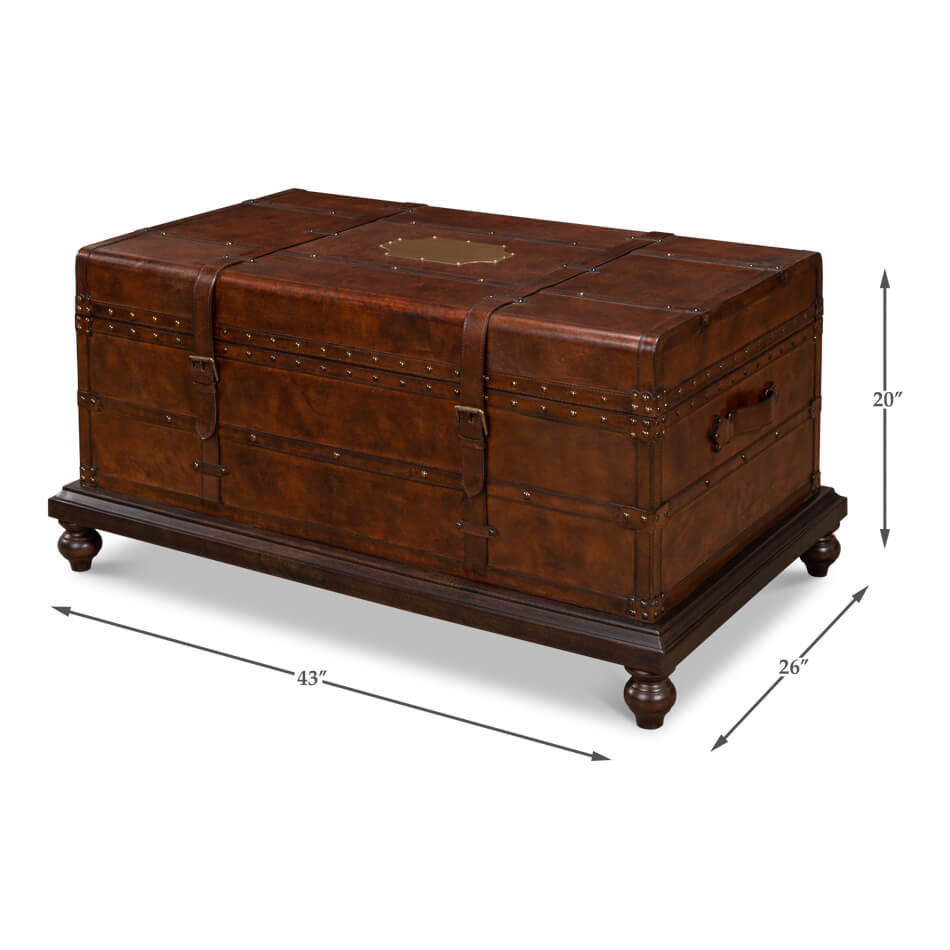 Dimensions displayed on brown leather trunk coffee table.