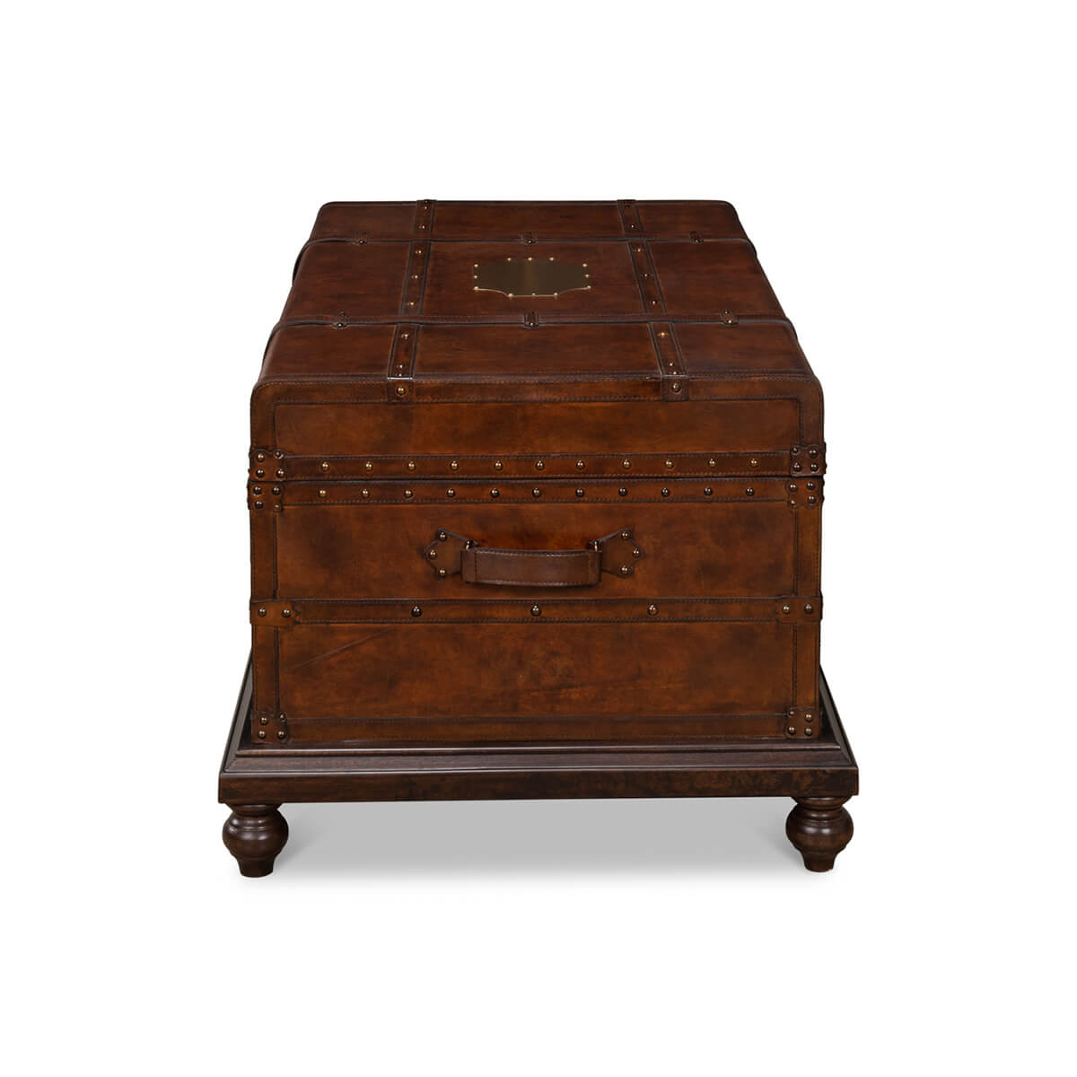 End view of brown leather trunk coffee table, sturdy base.