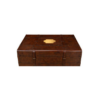 Top view, closed leather trunk coffee table with decorative plate.
