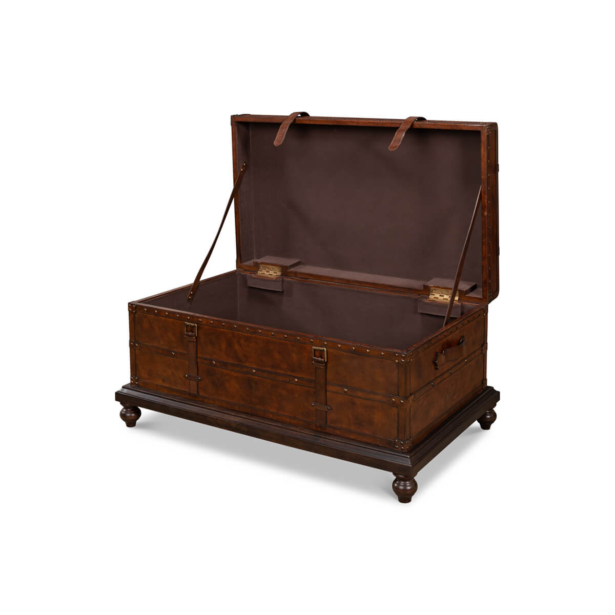 Open brown leather trunk coffee table showing interior storage.