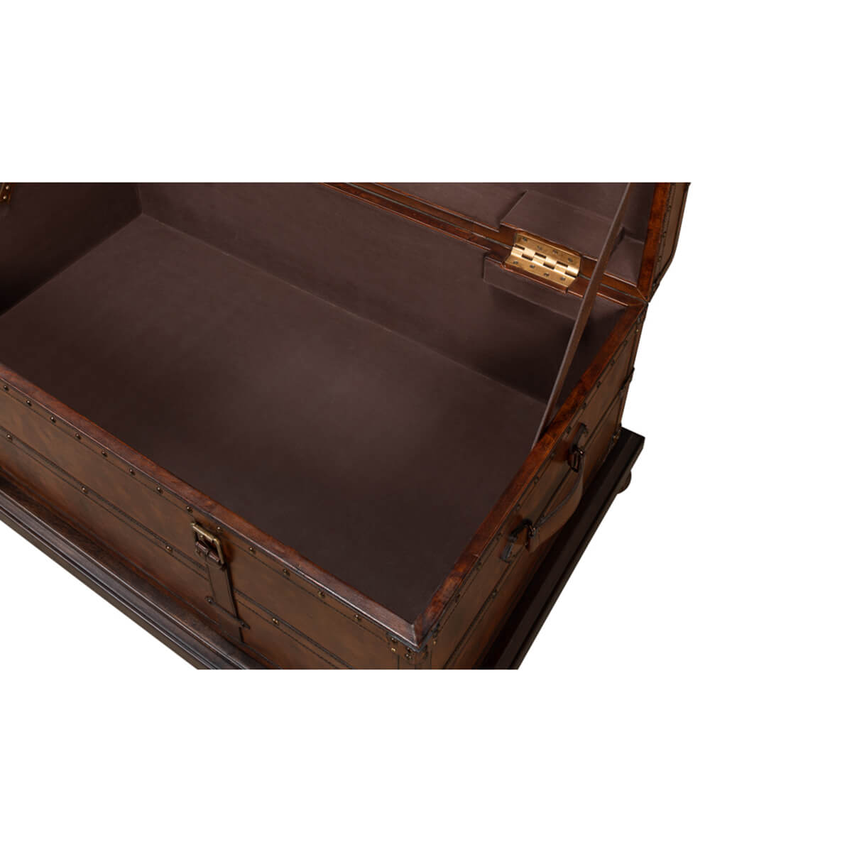 Interior close-up of open leather trunk coffee table storage.