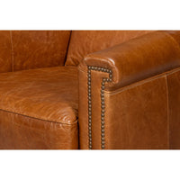 Light brown accent chair armrest details with studs.
