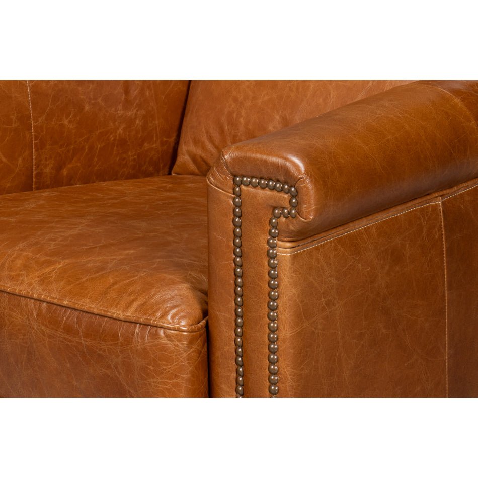 Light brown accent chair armrest details with studs.