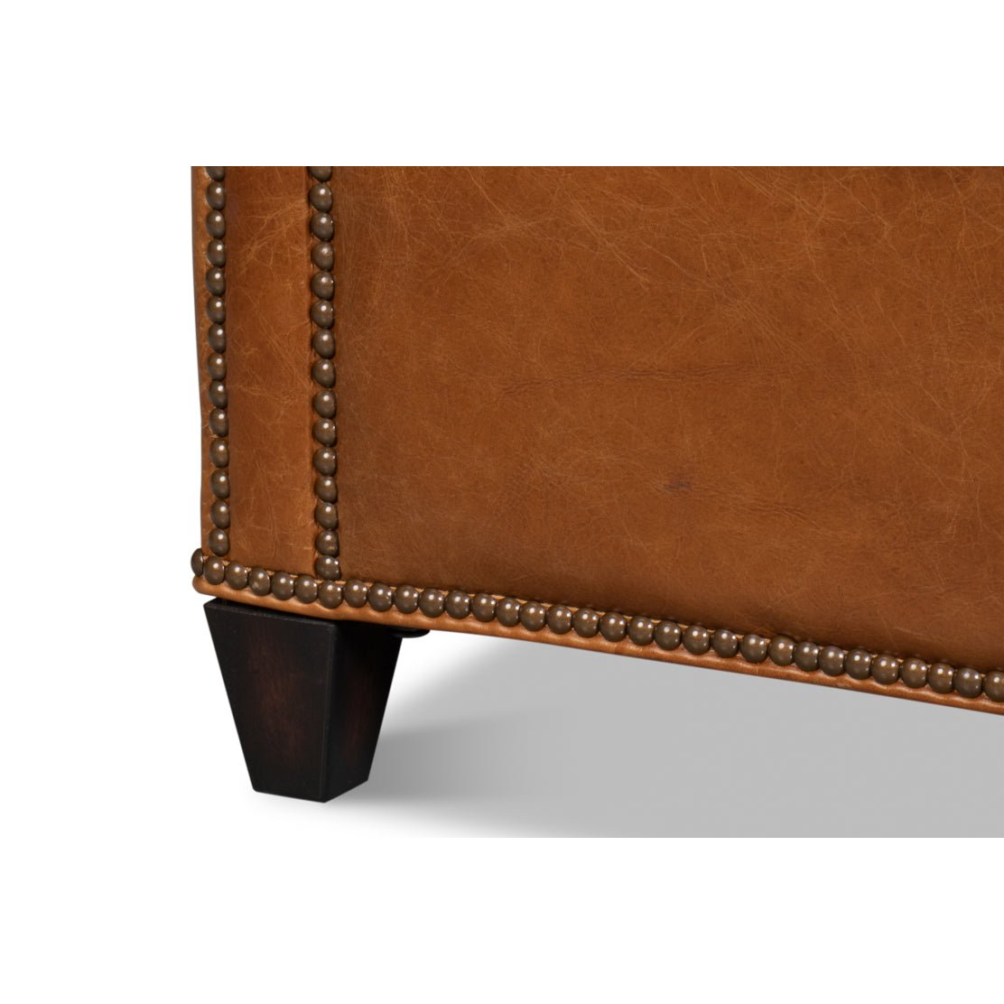 Light brown accent chair leg and base close-up.
