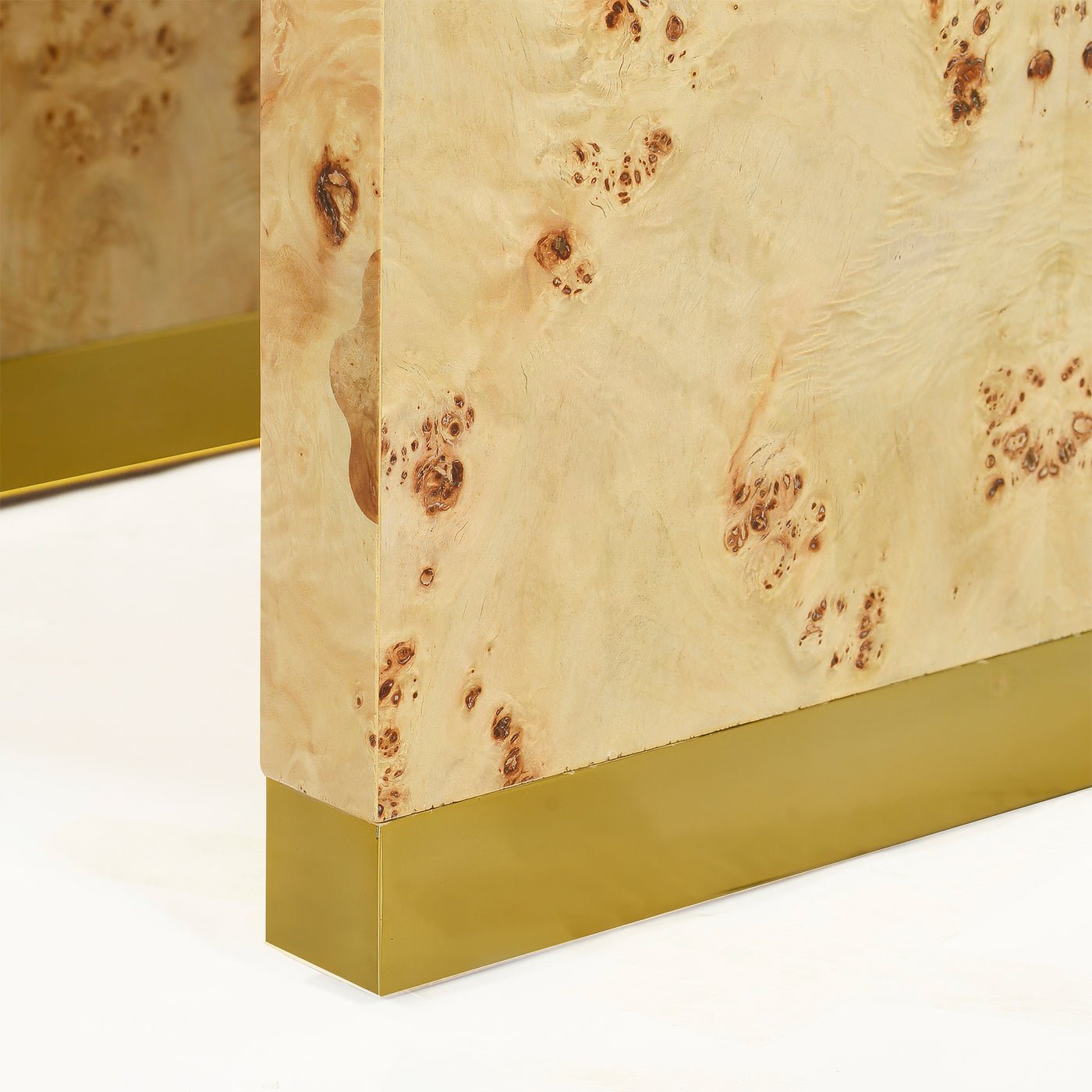 Close-up, burl wood and brass detail on side panel.