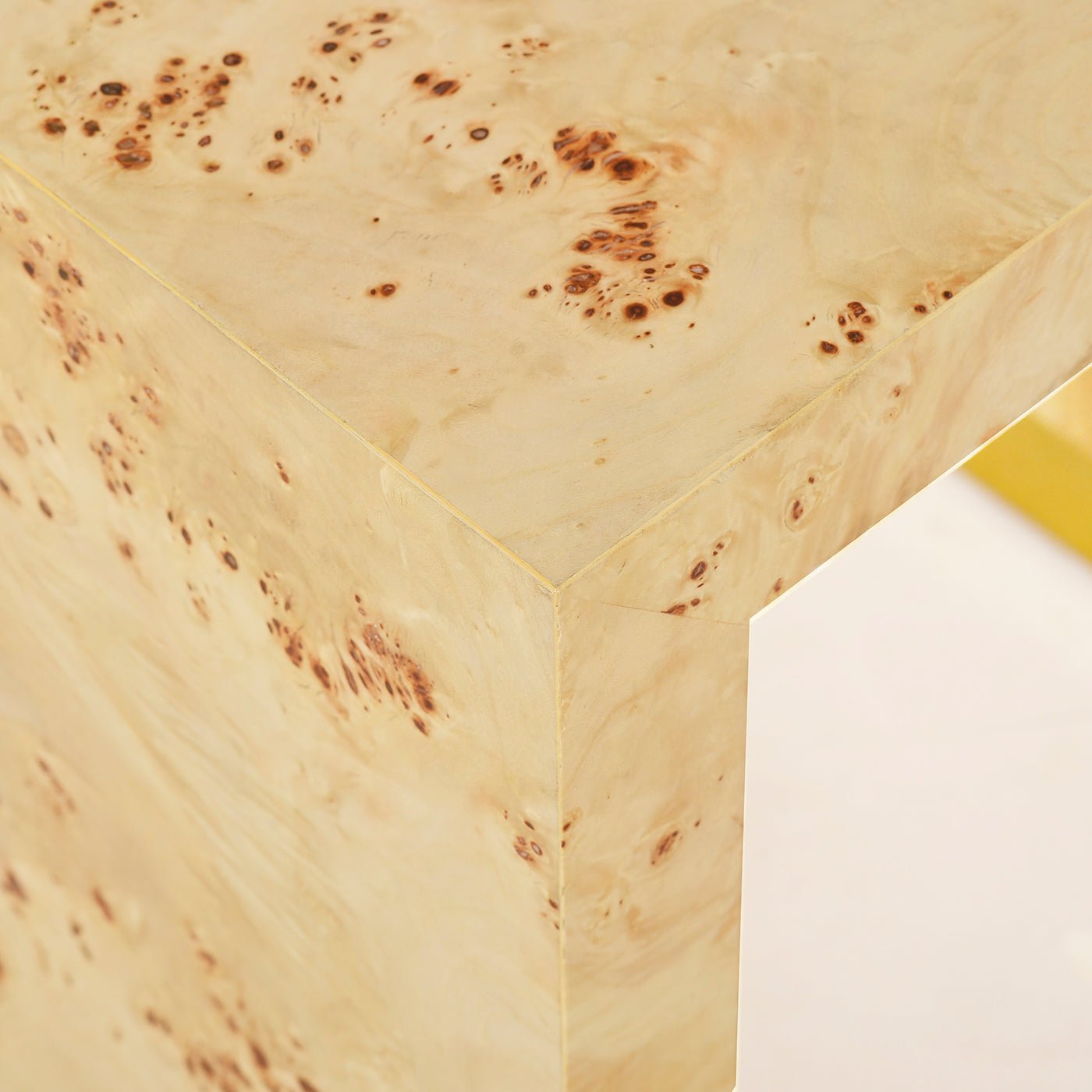Corner detail, burl wood texture and craftsmanship on table.