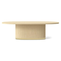 Light oak oval dining table, front view.