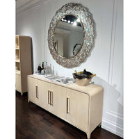 Light Hollywood Regency sideboard buffet, styled with mirror, decor displayed.