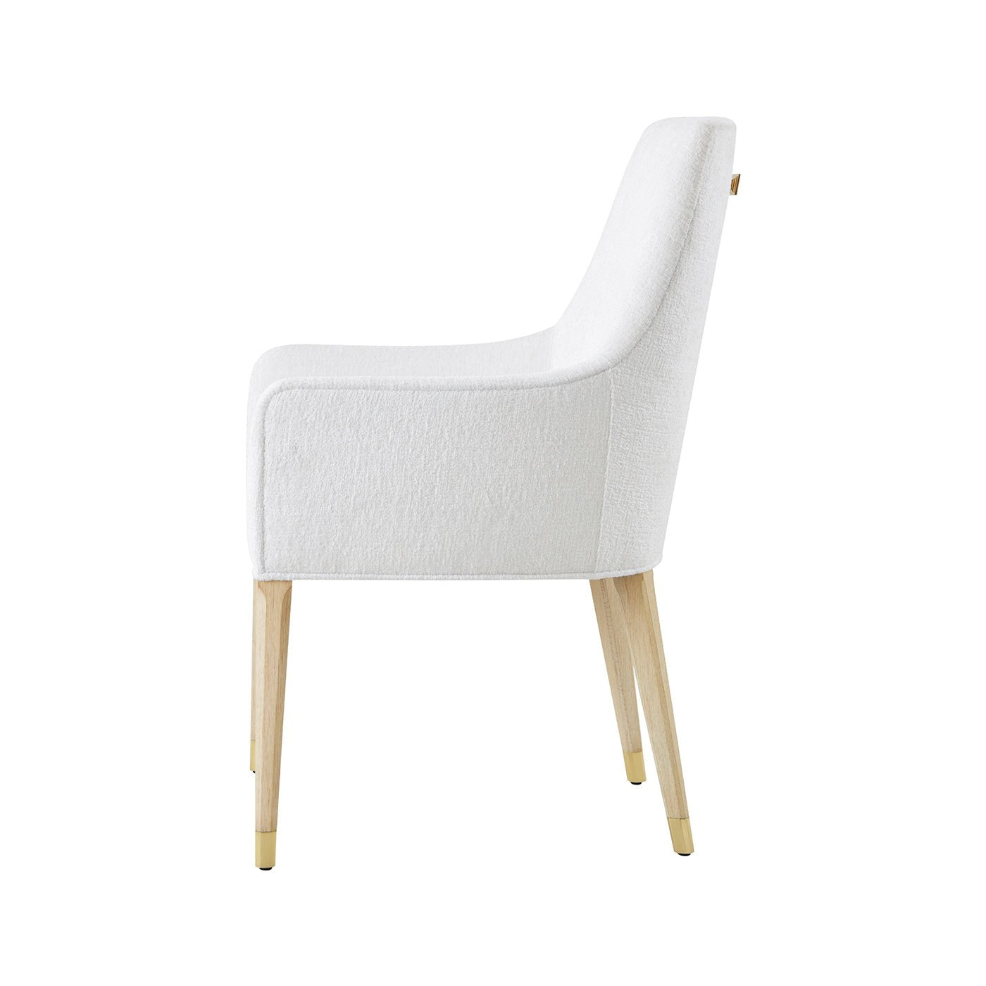 Side profile of white upholstered armchair with wooden legs.