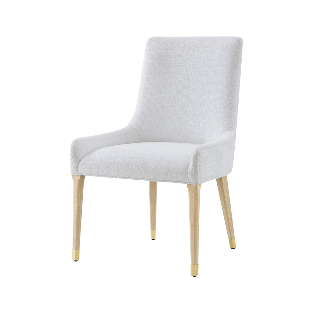 White upholstered dining chair, front angle view.