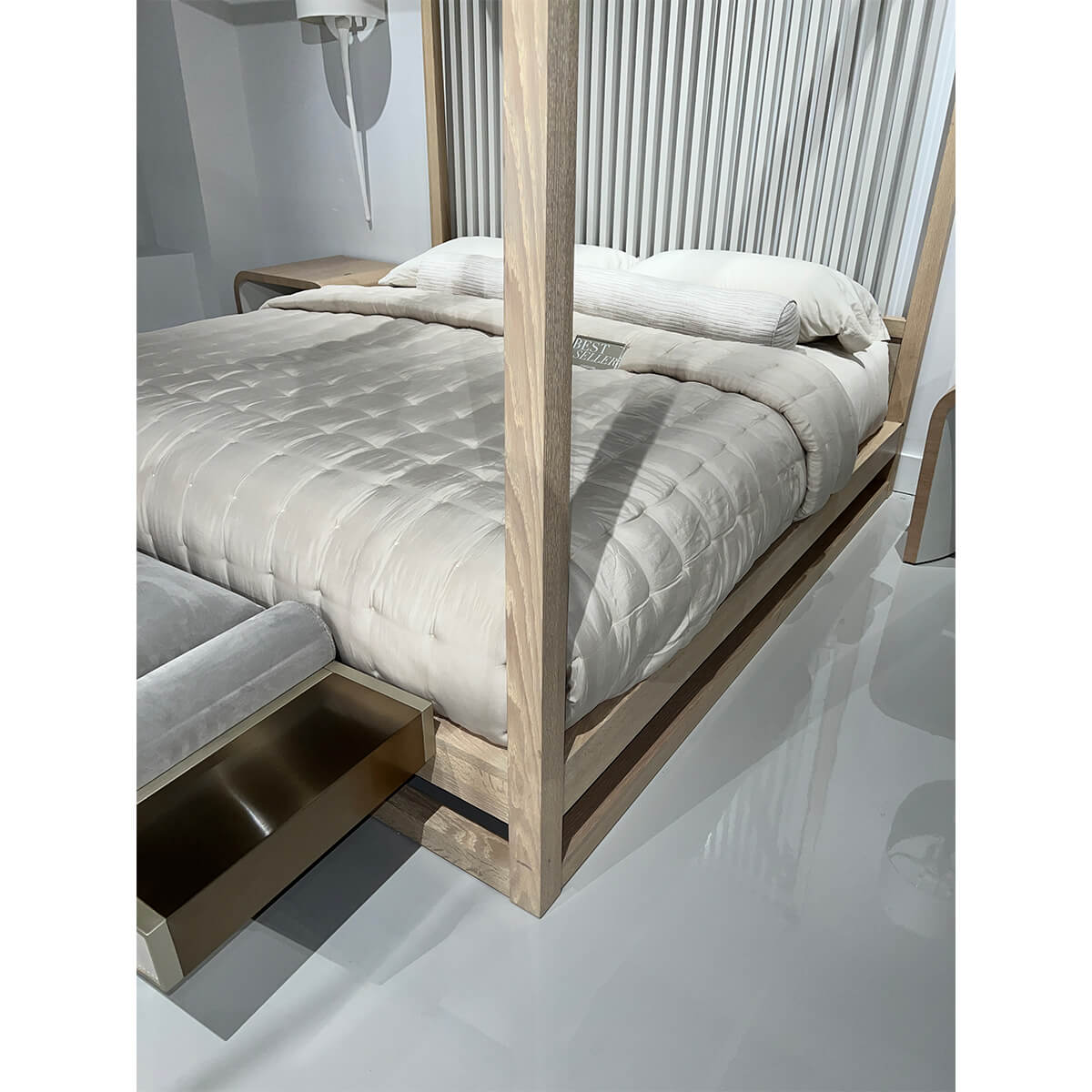 Close-up canopy bed corner, wood frame, glossy flooring.