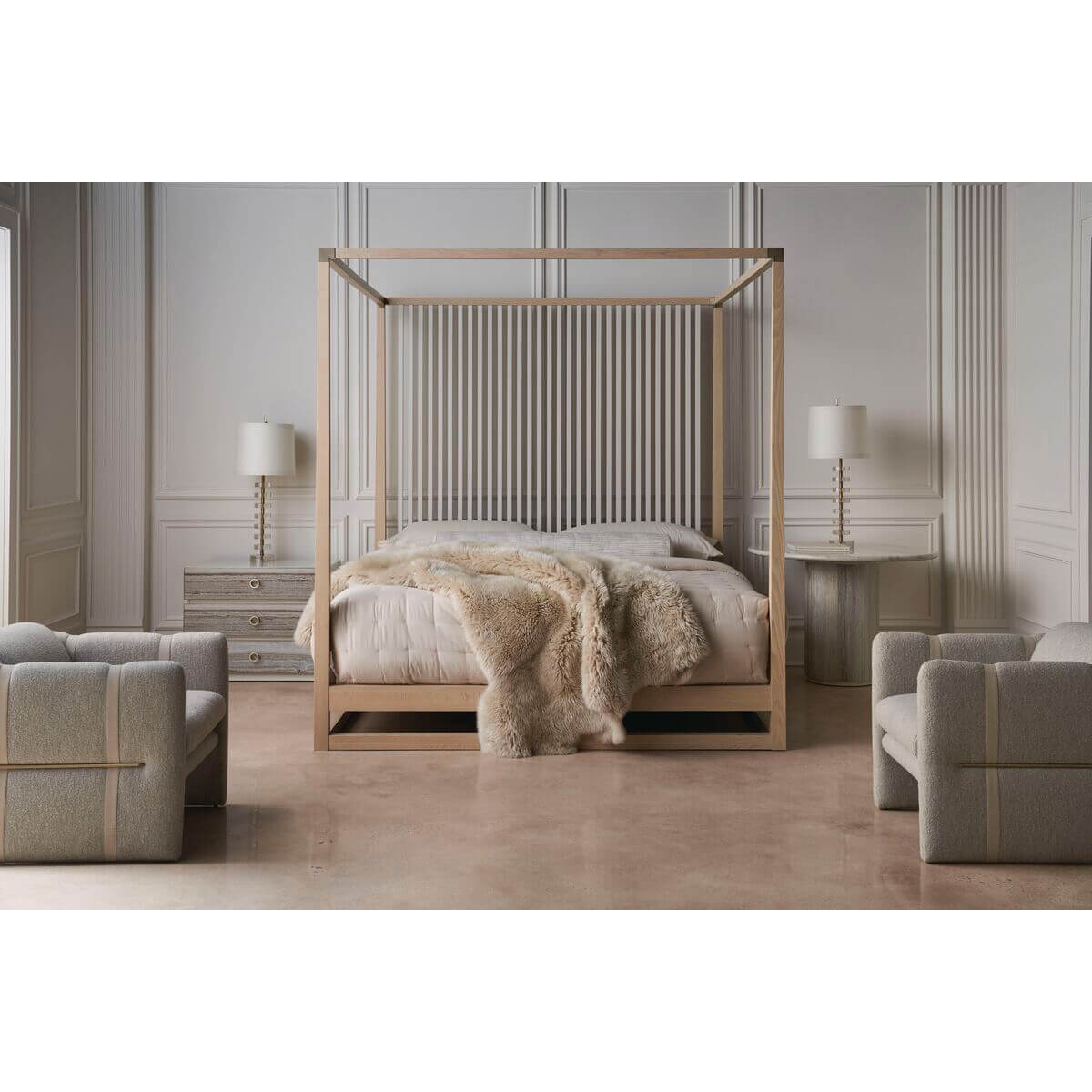 Canopy bed in spacious room, armchairs, light decor.