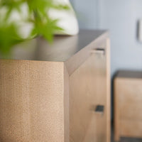 Close-up corner detail of modern nightstand in room.