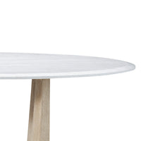 Close-up of white top on round dining table.