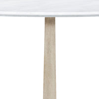 Detail of wooden leg on round dining table.