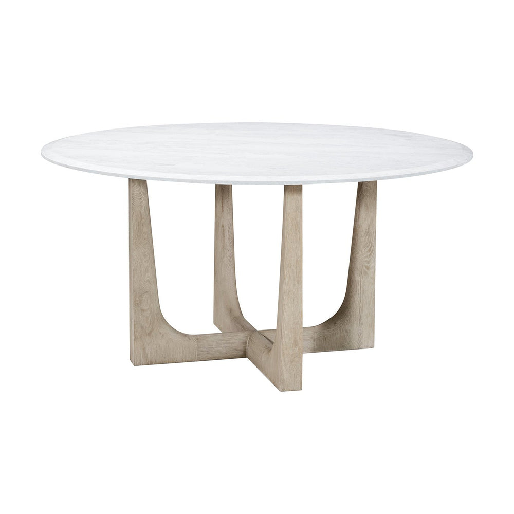Round dining table with white top and wood base.