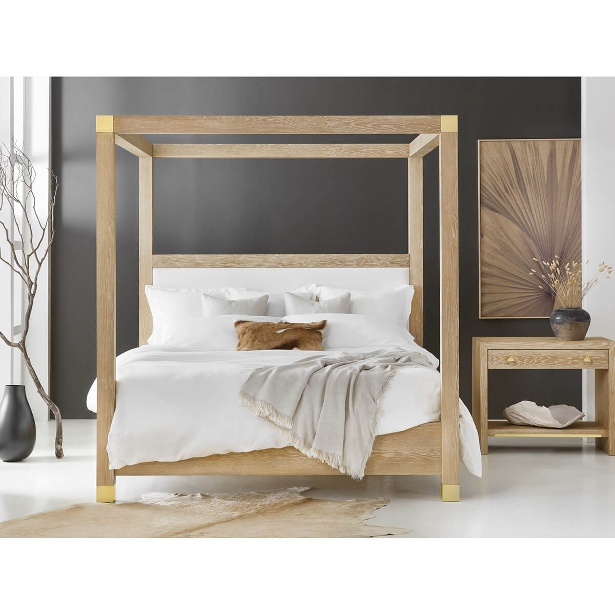 Light oak canopy bed with decorative accents and pillows.