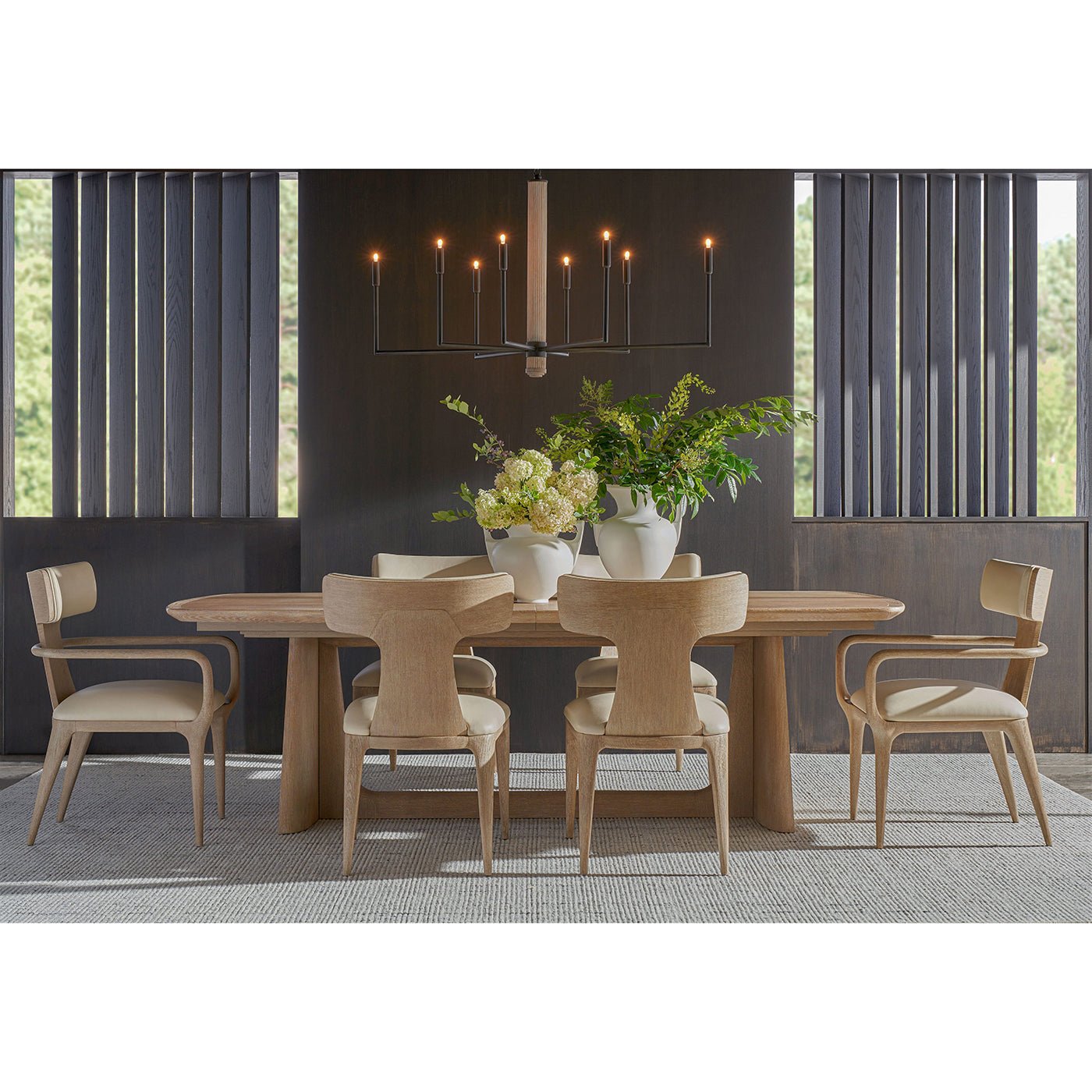 Dining room setup with light oak mid-century table and chairs.