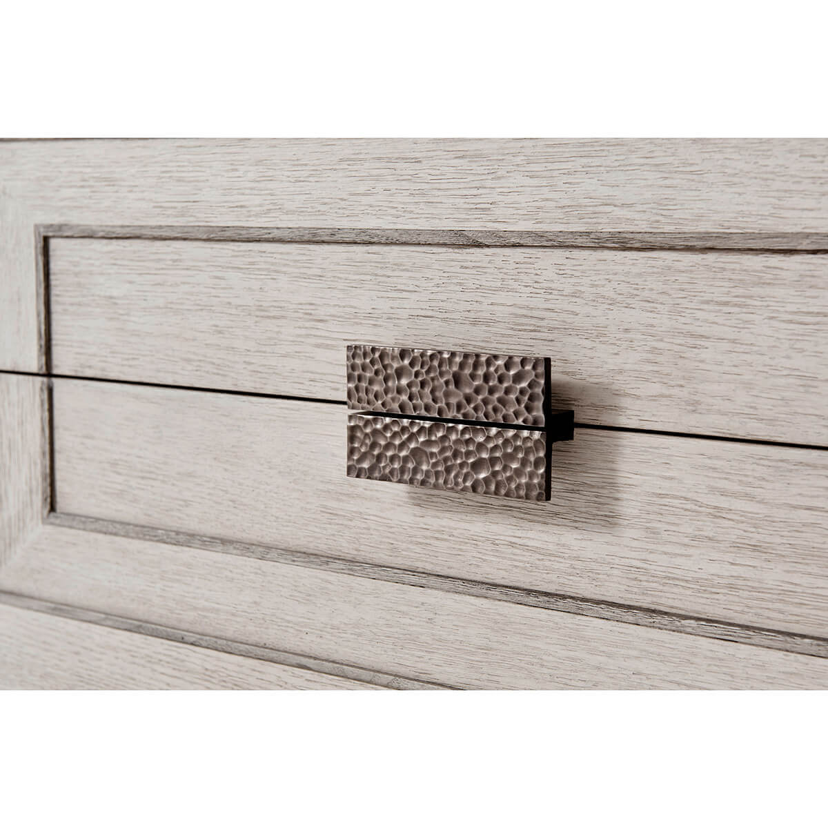 Close-up of nightstand's textured drawer handle.