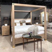 Bedroom set with bedside chest and canopy bed.