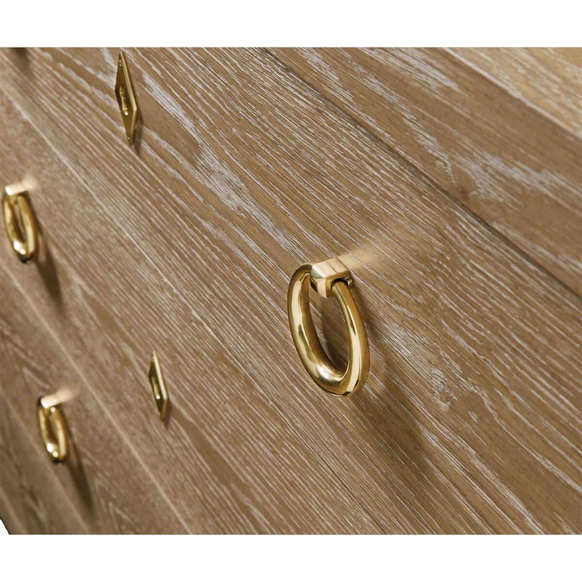 Close-up of dresser's brass handles and wood texture.