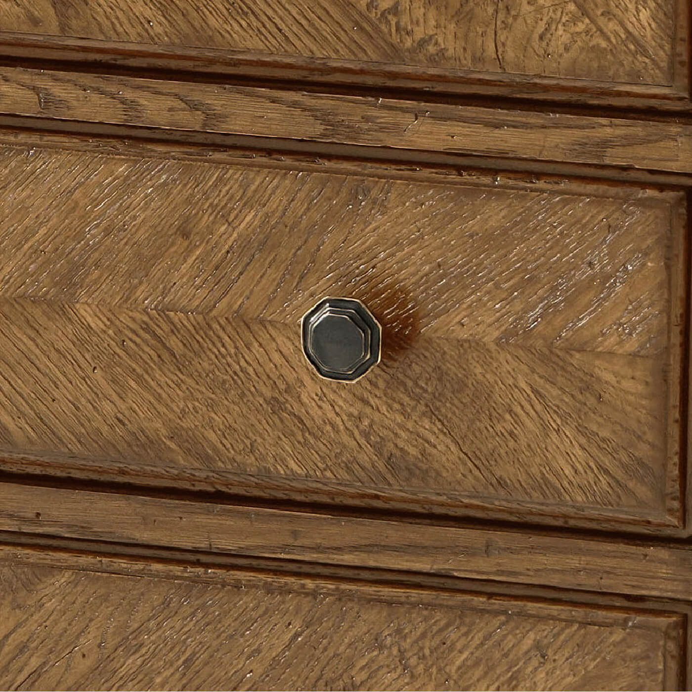 Close-up of drawer knob on parquetry dresser.
