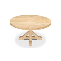 Light wood round dining table side view.