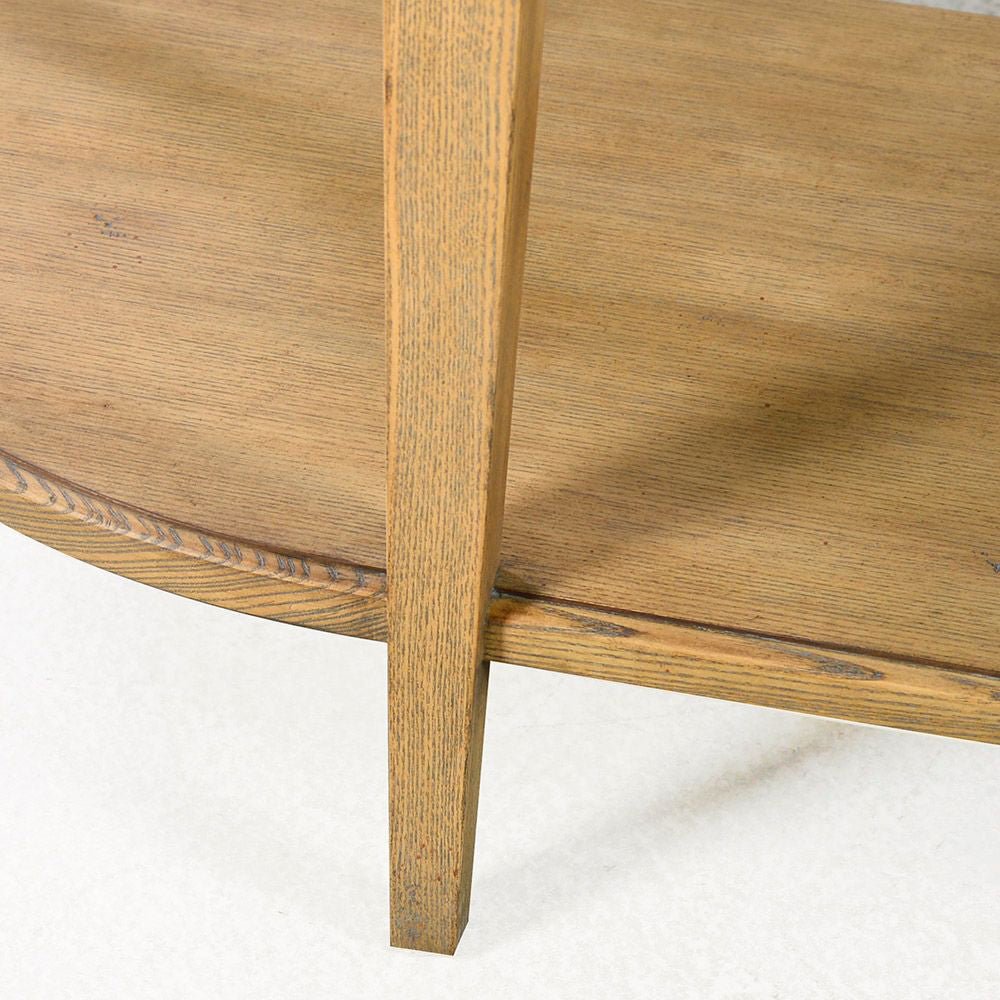 Leg and shelf detail of light wood console table.