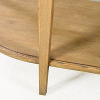 Leg and shelf detail of light wood console table.